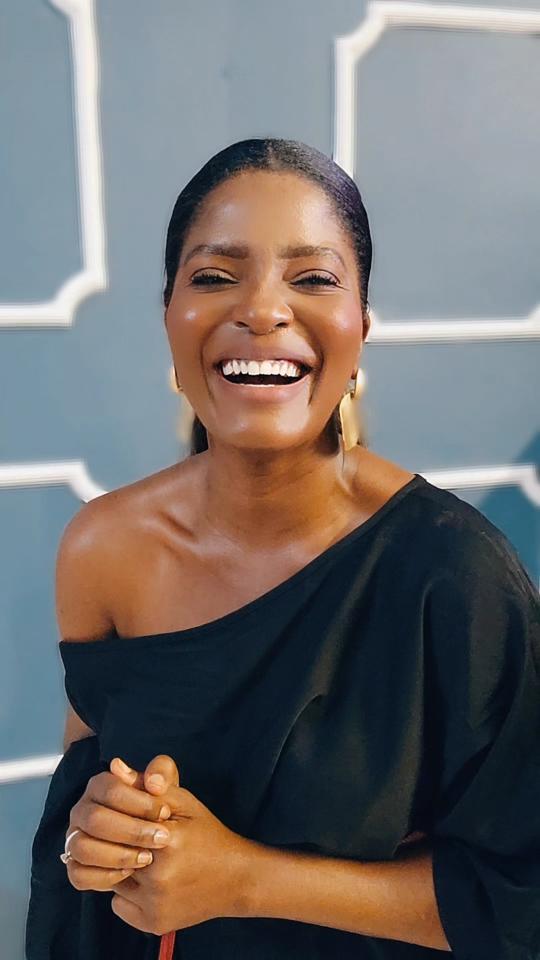 A woman smiling in a black top.
